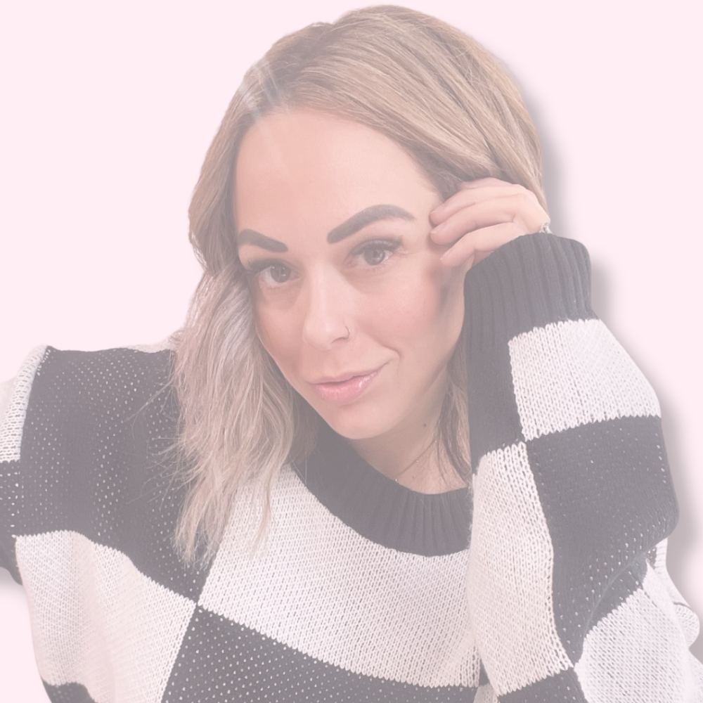 Woman wearing a black and white checkered sweater with 'pretty little things collective' text at the bottom.